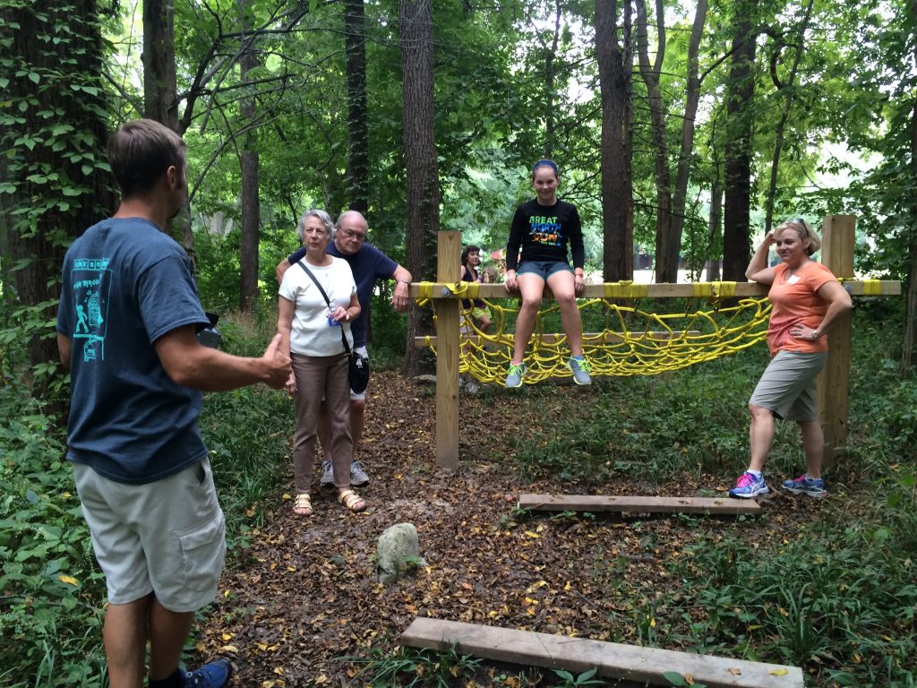 Brent Cummins explaining an obstacle to Kathy and Tom Jenkins, and Sarah and Jen Thomas